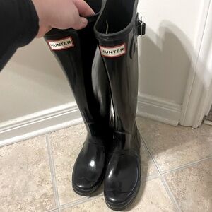 Glossy black hunter boots.